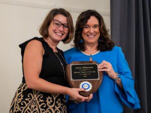 2026 Delaware Teacher of the Year Jenna DiEleuterio stands next to Delaware Education Secretary Cindy Marten holding a plaque.