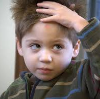 Child with hand on his head