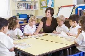 Teacher at table with children